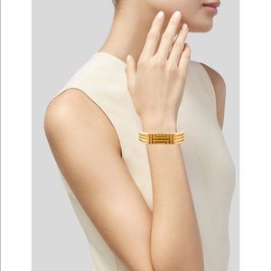 Tory Burch gold x Fitbit hinged bracelet